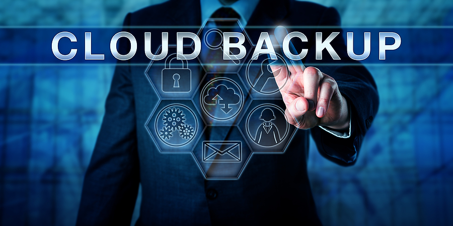 Enterprise end user is touching CLOUD BACKUP on a visual interactive virtual display. Business continuity and disaster recovery metaphor. Information technology concept for managed backup service.